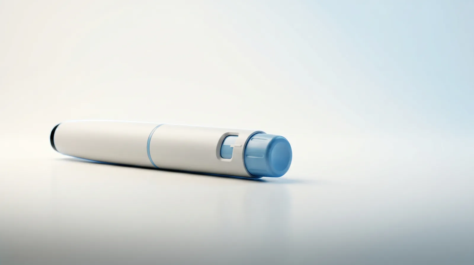 A clinical GLP-1 weight-loss auto-injector pen on a clean studio surface